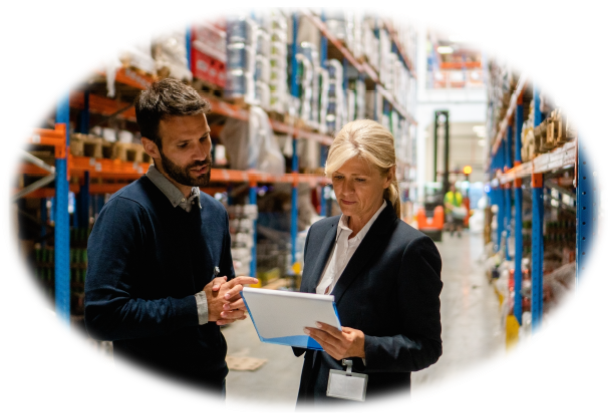 Man and lady in warehouse taking inventory.
